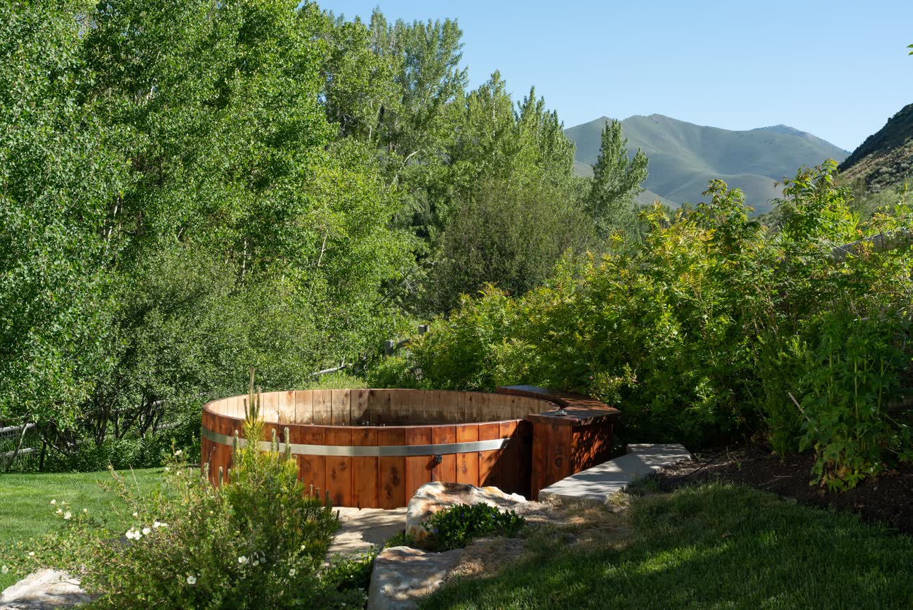 Cedar hot tub set into the garden below the residence