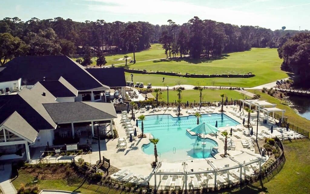 Aerial view of The Landings Marshwood Pool overlooking golf course fairway with resort-style deck and cabanas
