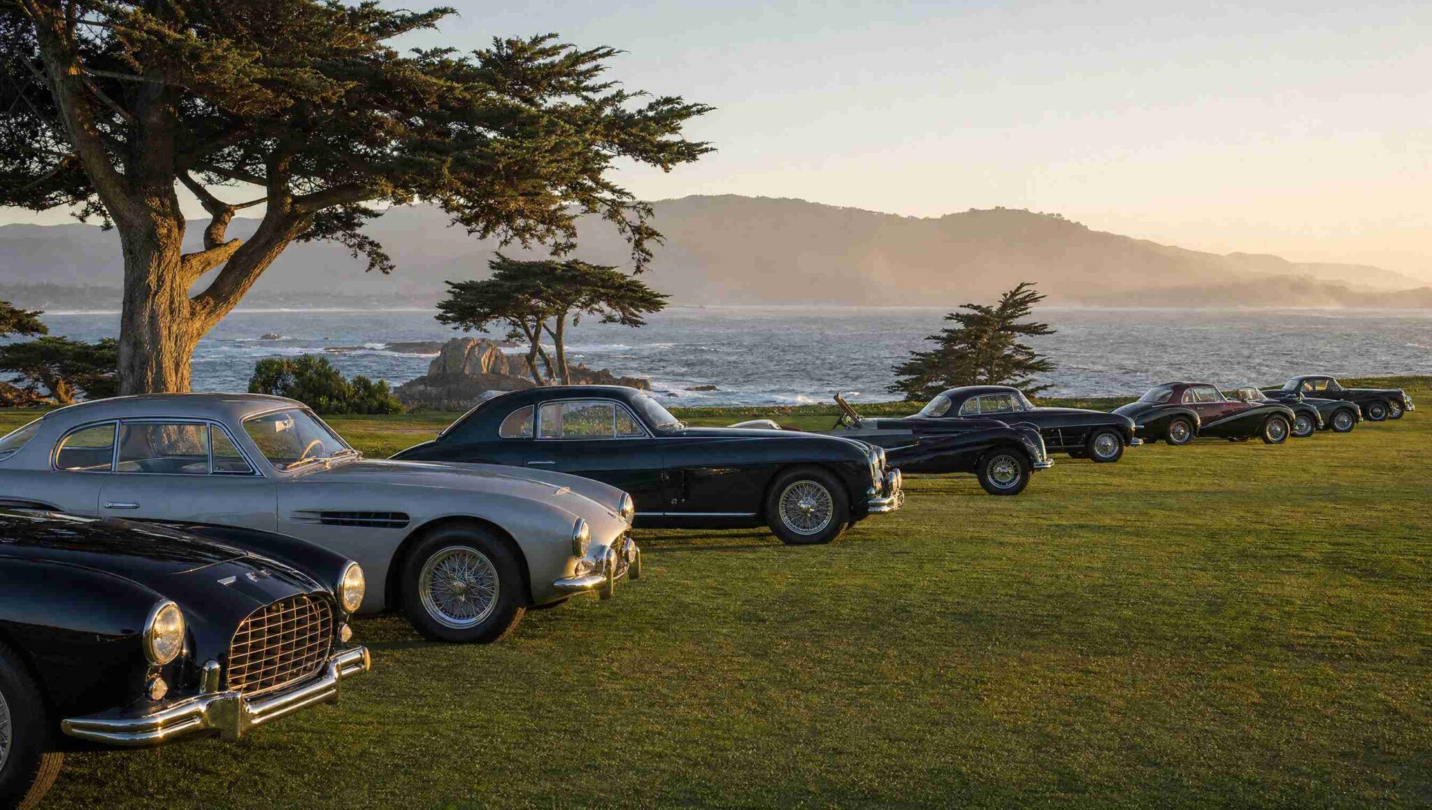 Classic cars displayed on a private club lawn during Monterey Car Week